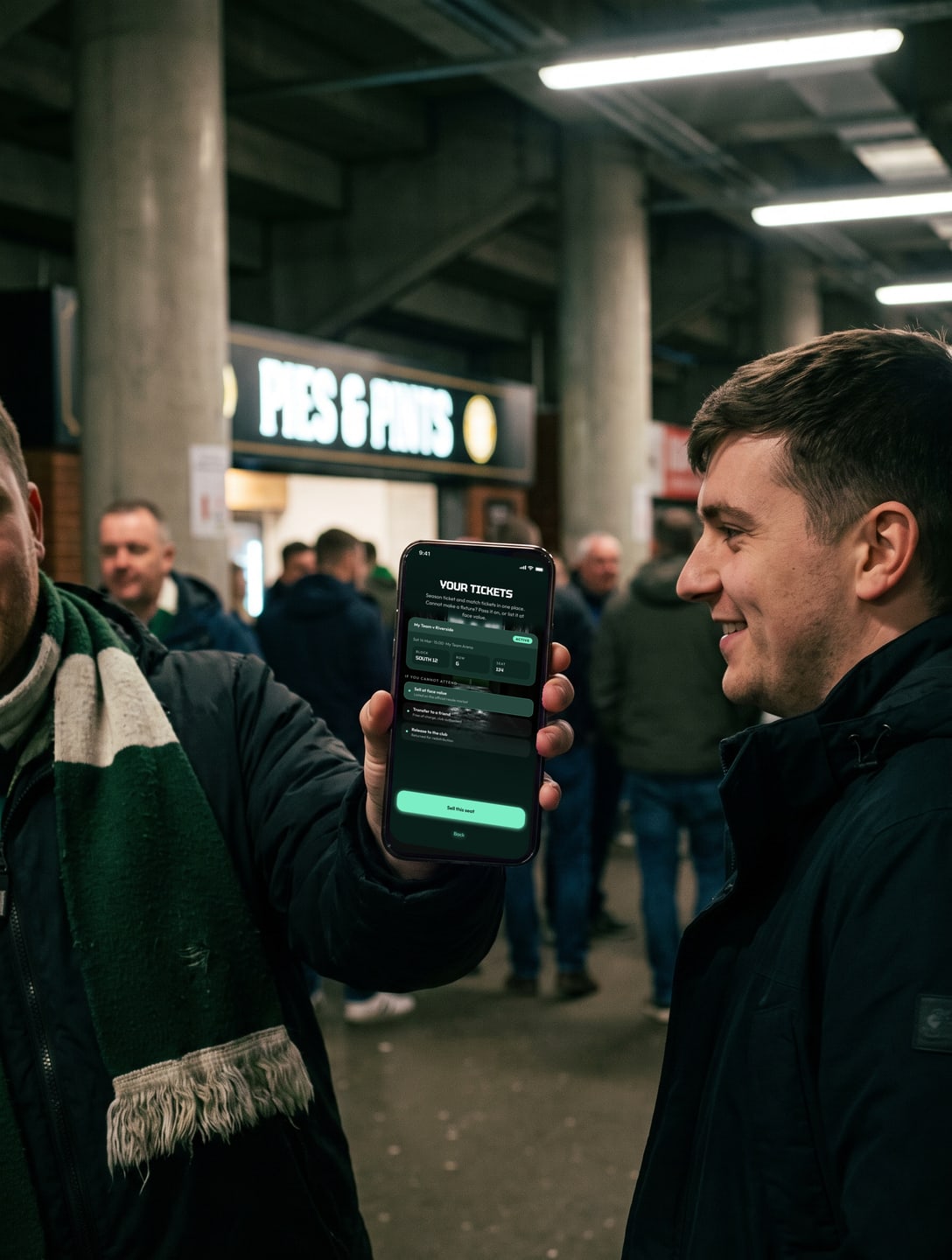 A supporter in the stadium concourse showing a friend the tickets on a phone