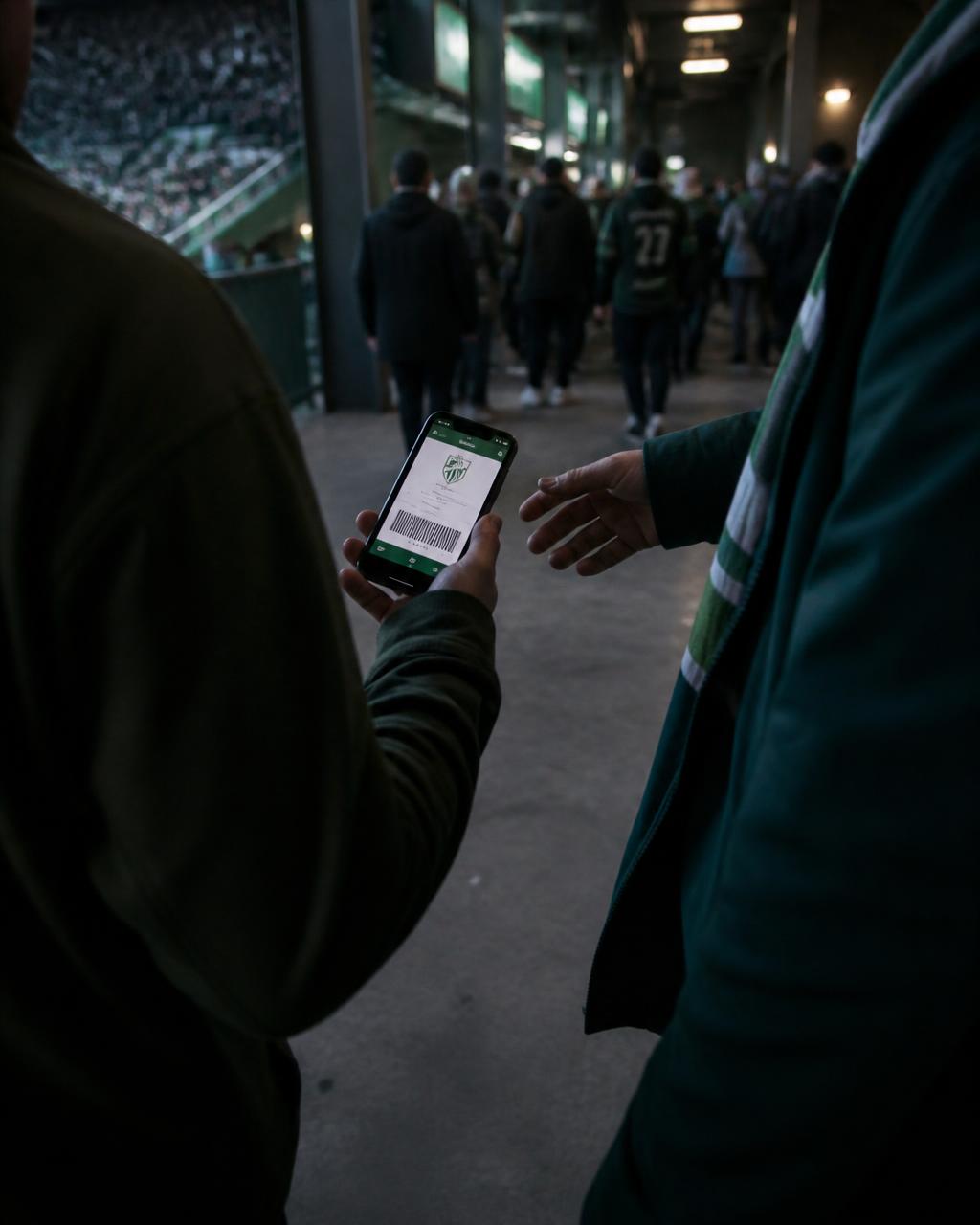 Two supporters passing a digital ticket between phones outside the ground